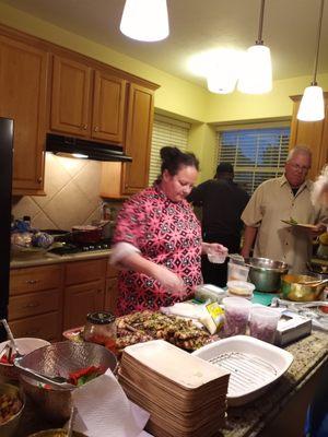 Chef Mary garnishing the chicken mole platters.