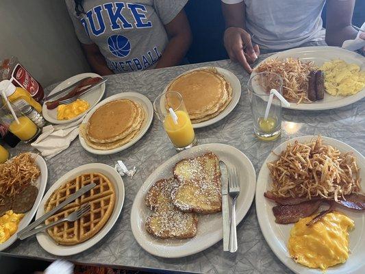 Waffle, pancakes, French toast, eggs with cheese, hash browns