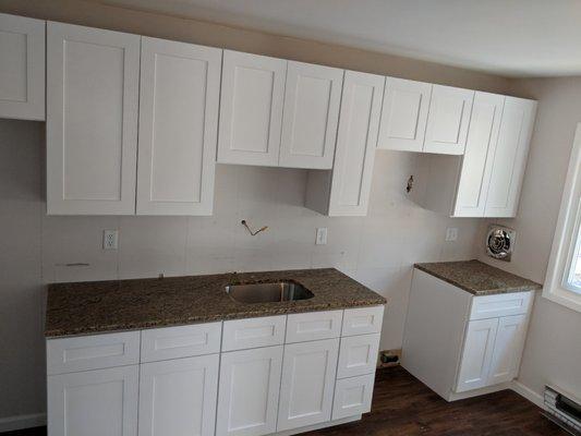 White Shaker cabinets with granite all complete. Time to add fixtures let the fun begin.