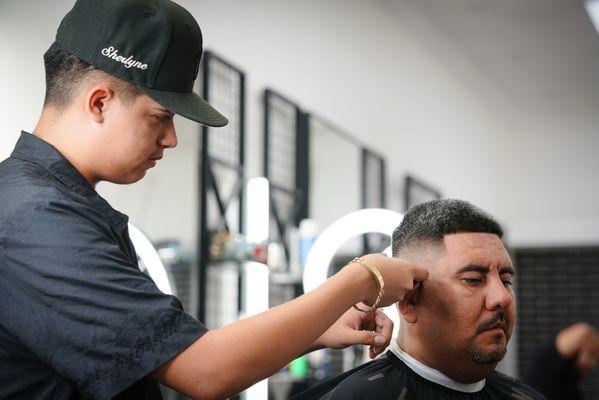 Barber Jose executing a razor fade to perfection