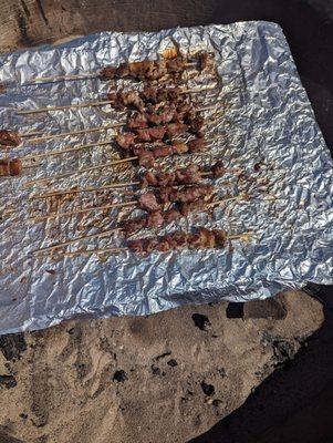 Grilling the lamb skewers at the beach