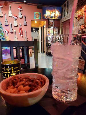 Bartender Tony came to my table to refill my snacks & bring a water. Even water comes in a tiki glass, & a fireplace on TV. Good vibes!