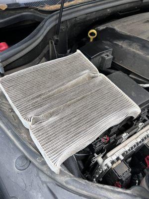 Filter was crushed and reinstalled incorrectly.  You cannot remove it from the engine compartment without doing this!