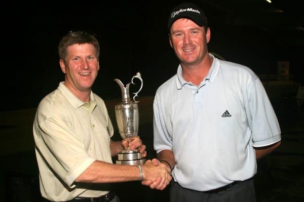 TOP 50 Teacher Don Peterson congratulates student Todd Hamilton on 2004 Open victory.