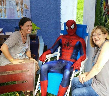 Spider man in for a 'tune up' at Hyde Park Street fair, fighting crime is hard on the body.