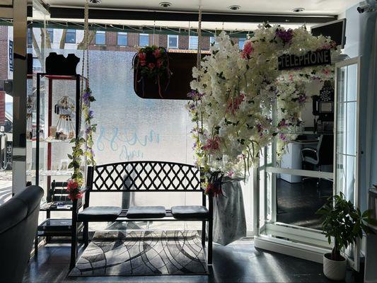 Front Window: local artisan jewelry display, waiting bench, mirrored telephone booth for photos