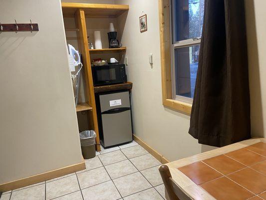 Mini fridge and seating table inside the king bed room.