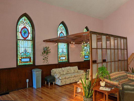 Small sitting area with the original stained glass windows