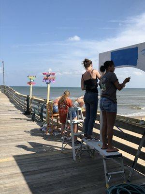 Sign painters giving us directions to lots of fun places