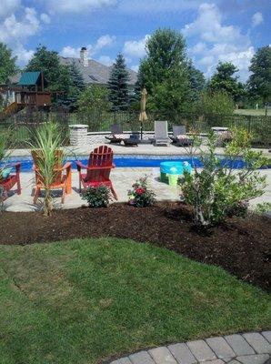 Finished poolside patio, wall and landscaping