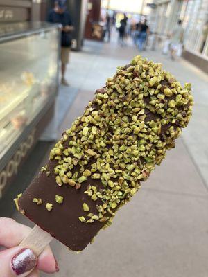 Raspberry dipped in dark chocolate rolled in pistachios