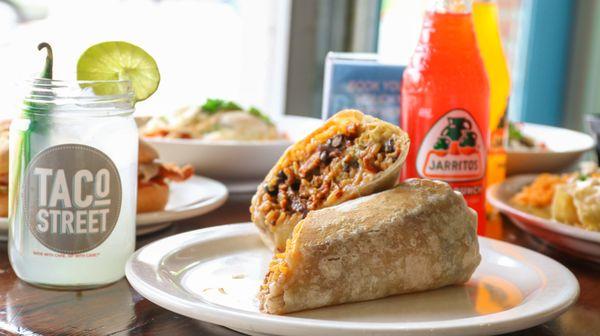 A selection of our delicious Mexican food. Featuring a warm burrito packed with rice, beans, guacamole and pork