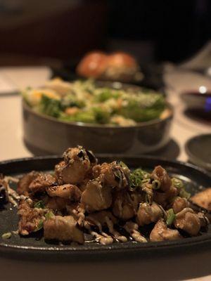 Crispy Eggplant with Caesar salad and rolls in the background