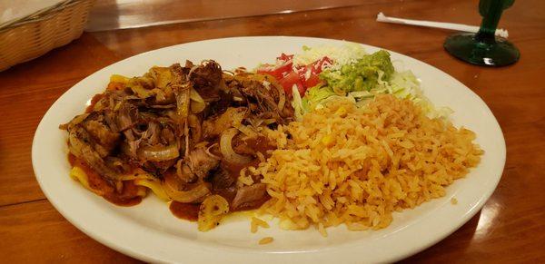 The enchiladas carnitas topped with caramelized onions with a side of rice and the guacamole salad.