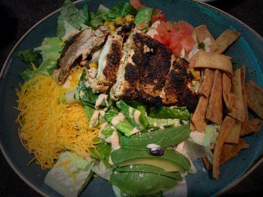 Southwest Chicken Salad: Chicken breast, corn, black bean fiesta, tomatoes, cheese, avocado & tortilla strips all atop romaine lettuce.