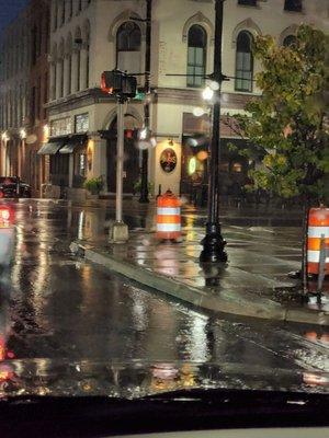 A rainy outside view of Jake's on the corner.