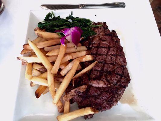 Ribeye steak, spinach and fries.