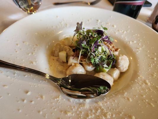 Gnocchi appetizer with cheese, Diced pears, and crumbled walnuts.