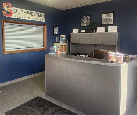 Reception area staffed by patient care coordinator.