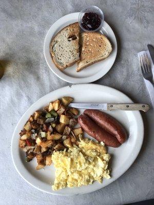 Scrambled eggs with country potatoes and reindeer sausage and light rye toast