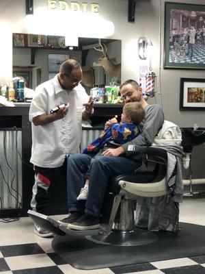 Eddie patiently working to cut a 2 year old's hair :)