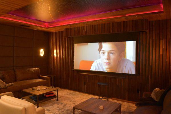 Media Room with 85" TV and custom cinema scope drop down screen for a true media experience.