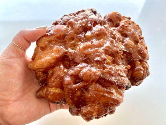 Apple fritter. Small bits of apples with sweet cinnamon syrup & glazed. Crunchy fritter edges are the best. They're big so, share! Or not.