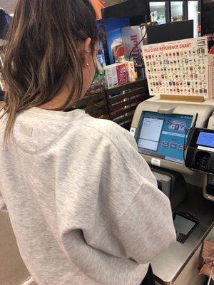 A female customer using the self checkout system