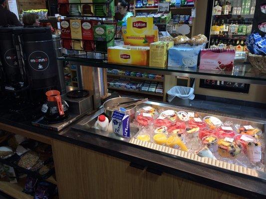 Open breakfast bar area with fresh pressed OJ, fresh fruit, tea, parfaits, and coffee