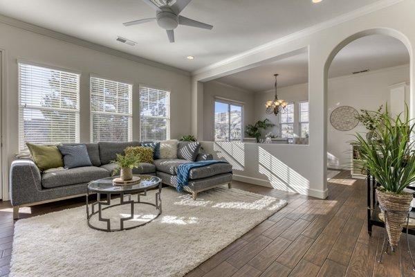 Sunlight pours into this open living room, shot for a real estate listing.