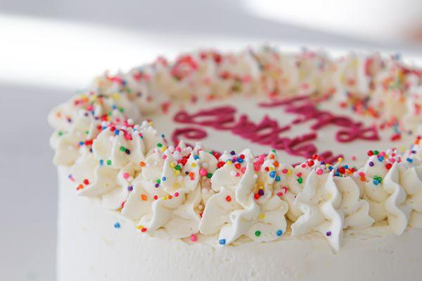 Gluten-free cake with whipped topping, close-up