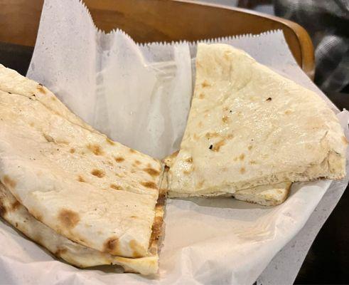 Garlic Naan - Plain flat white bread baked in a clay oven.