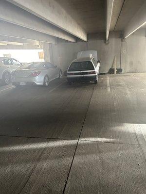 This car has been on the first floor parking garage right at the entrance on blocks with no tires not even an engine or license plates