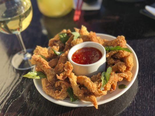 Popcorn Chicken a favorite among kids. Chicken breast marinated with fresh herbs coated with flour and fried with Thai basil leaves.