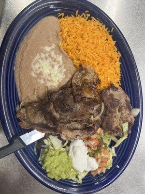 carne asada  thin slices of rib-eyesteak server with rice and beans,guaca salad and tortillas