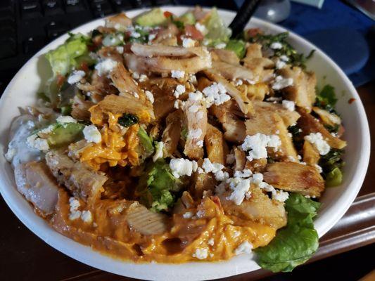 chicken bowl on lettuce with avocado and hummus