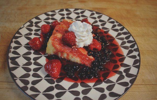 The famous of our desserts*Ruby Port raspberry/blueberry sauce over Lemon Curd cake.