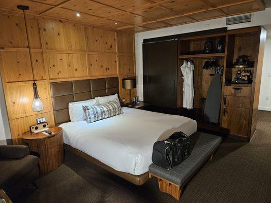 Inside view of room towards closet with snack area and fridge behind door