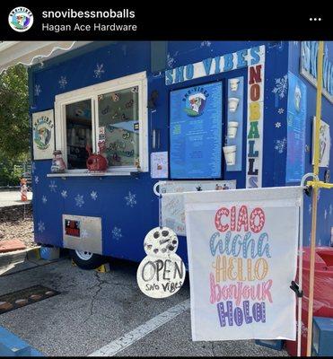 Our snoball stand Sno Vibes SnoBalls, little welcome flags around the stand