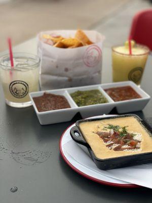 Coin margarita, spicy pineapple margarita, Chips & Salsas, and queso