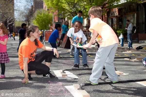 Instructor Caitlin Pontrella oversees two children learning how to play balance joust.