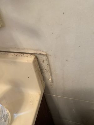 Sink coming out of the wall in bathroom