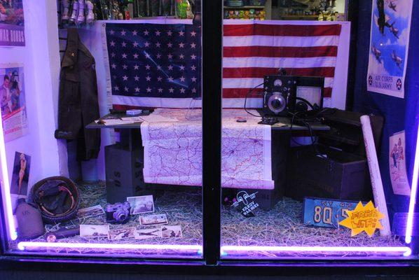 Skillman Pets 1940's WWII window display. Authentic era map of Berlin, radio, headset, Army Air Corps jacket and original 48 star USA flag.