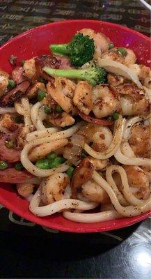 Udon noodles with chicken, shrimp, sausage, broccoli & peas.