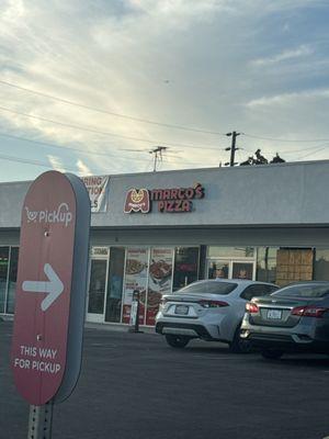 Marcos Pizza with two up front parking spots.