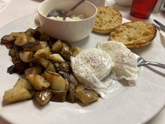 Poached eggs, homefries with onions, cup of grits, and english muffin.