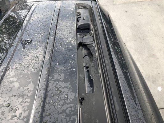 Close up view of the luggage rack rail that was damaged inside the car wash