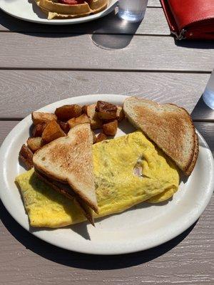 Meat lovers omelette with pan fries and sourdough toast