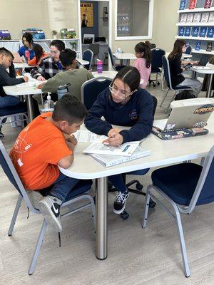 Miss Alyssa, our writing and reading tutor is working on reading comprehension skills with her student.