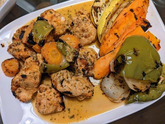 Savory tender and flavor shish tawook chicken cubes with grilled veggies.